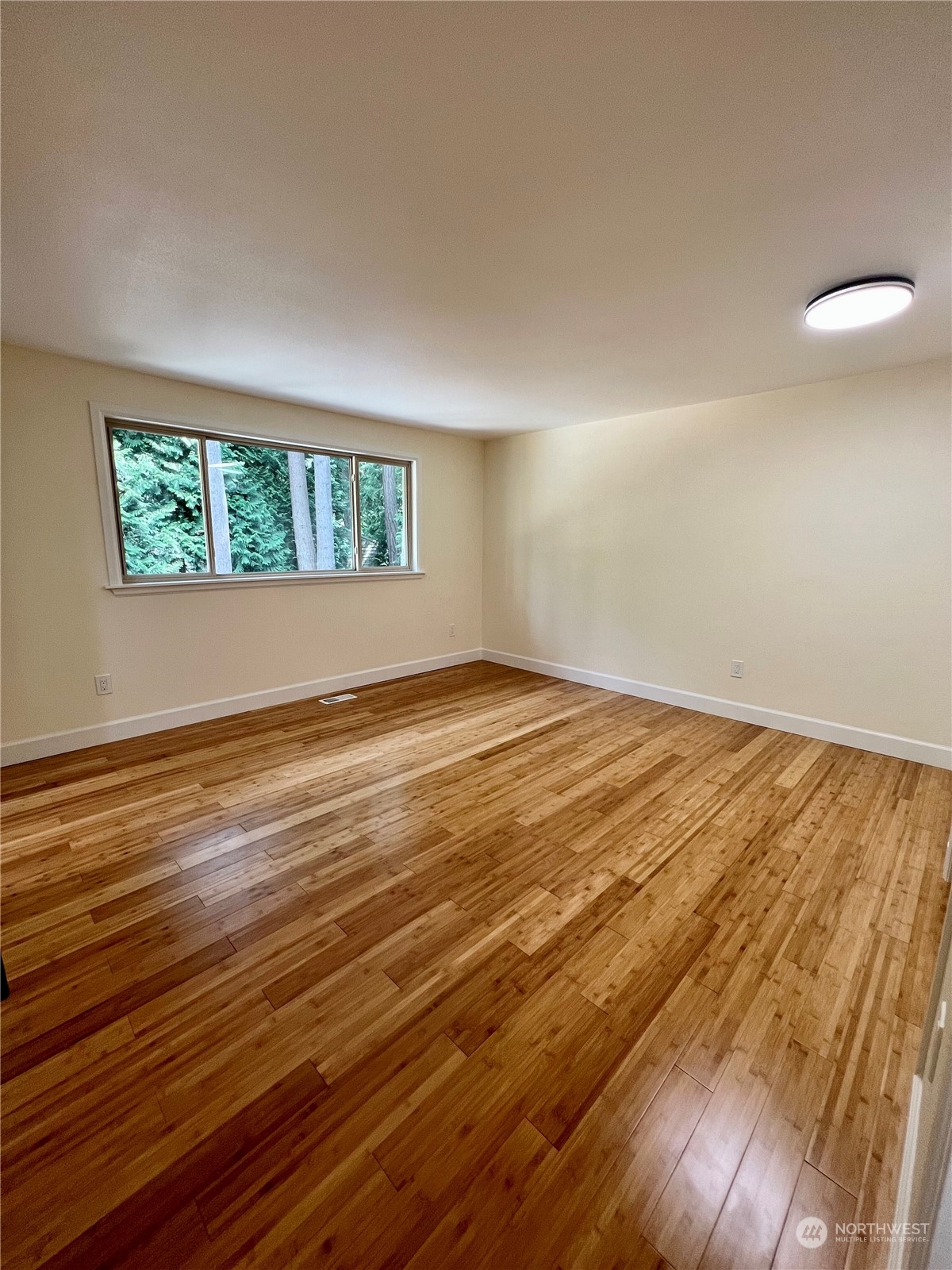 22925 49th Avenue Southeast Bothell, WA 98021 - Photo 16 of 40 an empty room with wooden floor and windows