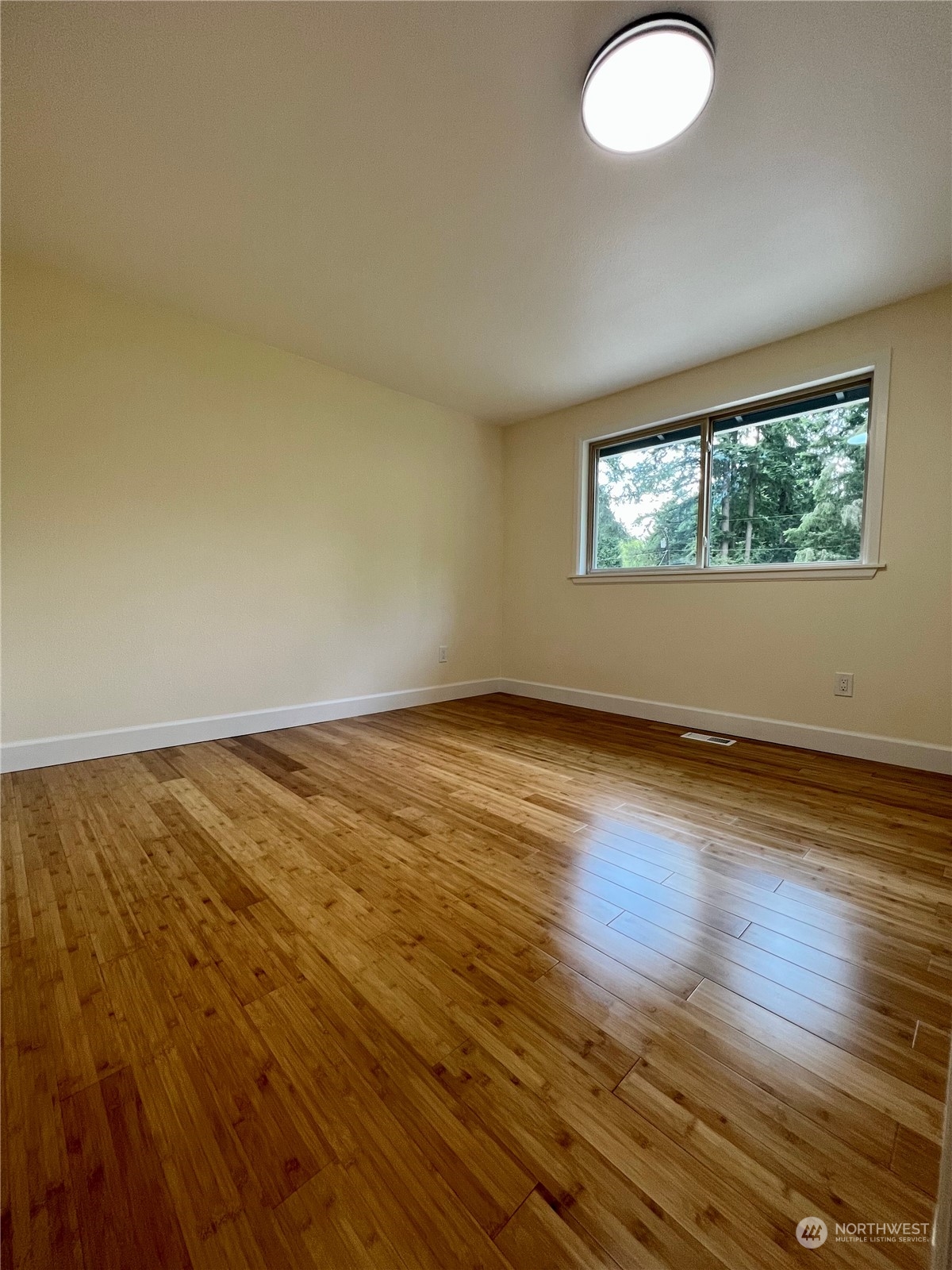 22925 49th Avenue Southeast Bothell, WA 98021 - Photo 18 of 40 an empty room with wooden floor and windows