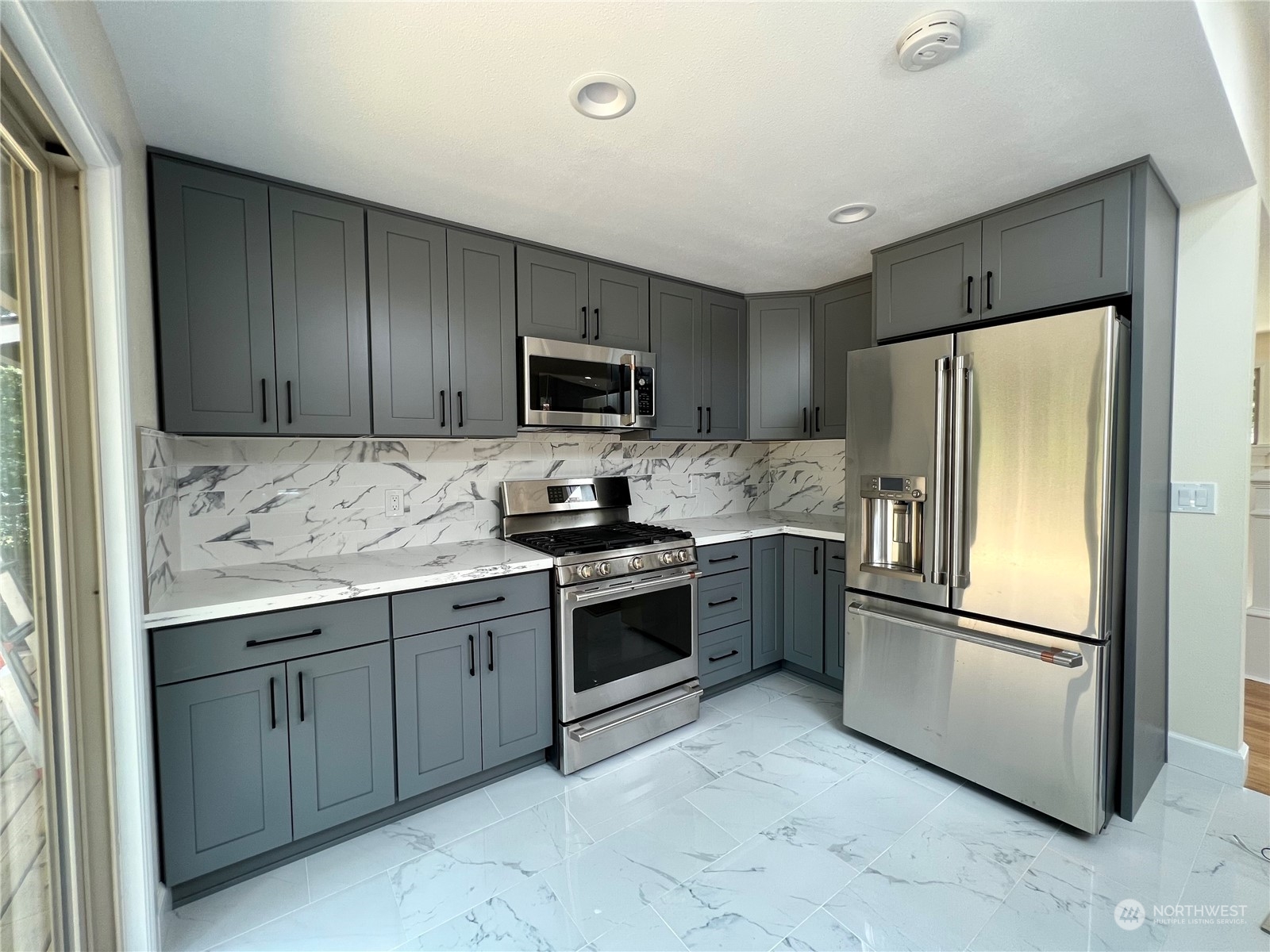 22925 49th Avenue Southeast Bothell, WA 98021 - Photo 10 of 40 a kitchen with granite countertop stainless steel appliances and refrigerator