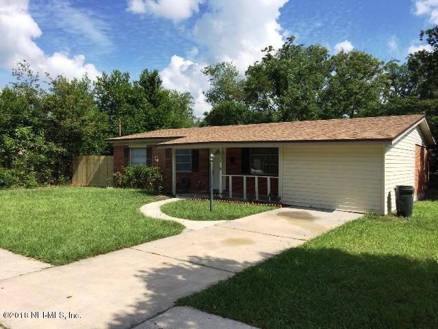 7391 Wheat Road Jacksonville, FL 32244 - Photo 1 of 26 a front view of a house with a yard and garage