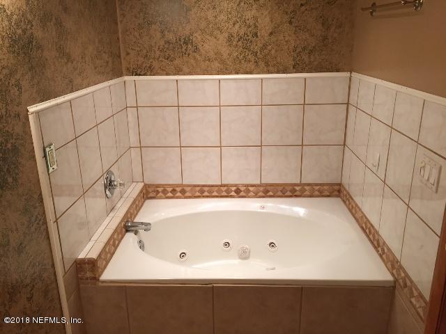 7391 Wheat Road Jacksonville, FL 32244 - Photo 12 of 26 a bathroom with a bathtub