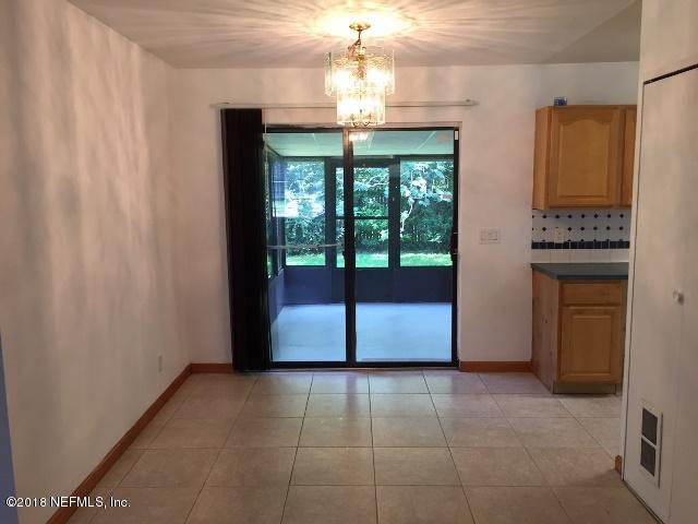 7391 Wheat Road Jacksonville, FL 32244 - Photo 7 of 26 a view of a kitchen with a sink and a chandelier