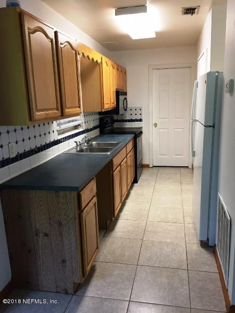 7391 Wheat Road Jacksonville, FL 32244 - Photo 8 of 26 a kitchen with stainless steel appliances a sink stove and refrigerator