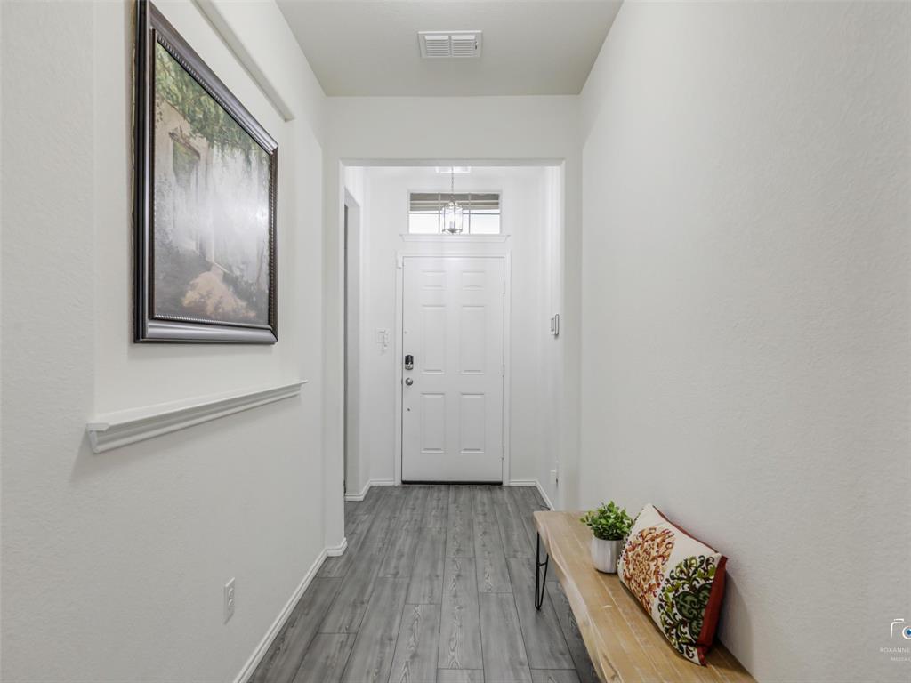 4517 Ashmark Road Aubrey, TX 76227 - Photo 5 of 26 a view of a hallway with wooden floor and closet