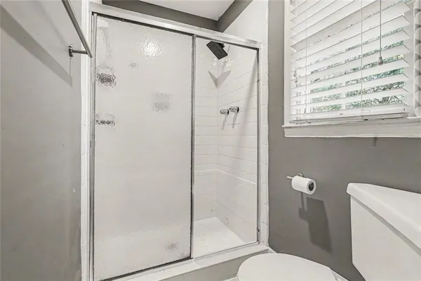 a bathroom with a shower and toilet