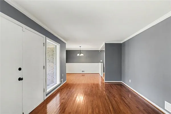 a view of empty room with wooden floor