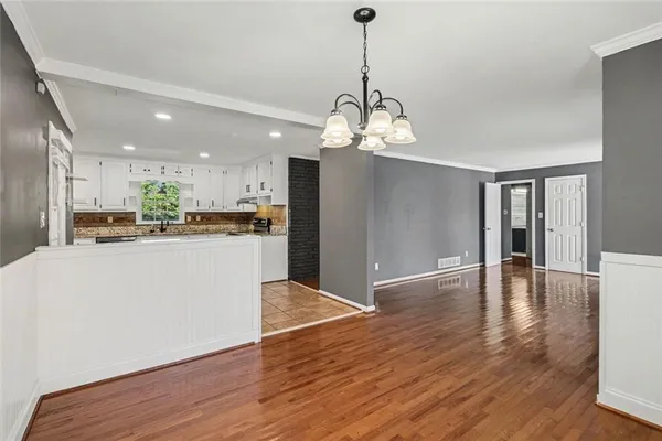 a view of a kitchen with granite countertop stainless steel appliances and wooden floor