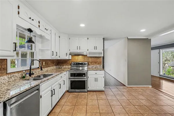 a kitchen with a stove a sink and a refrigerator