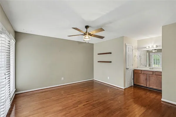 an empty room with cabinet and a ceiling fan