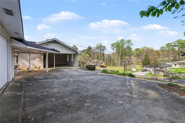 a view of a house with a yard and pathway