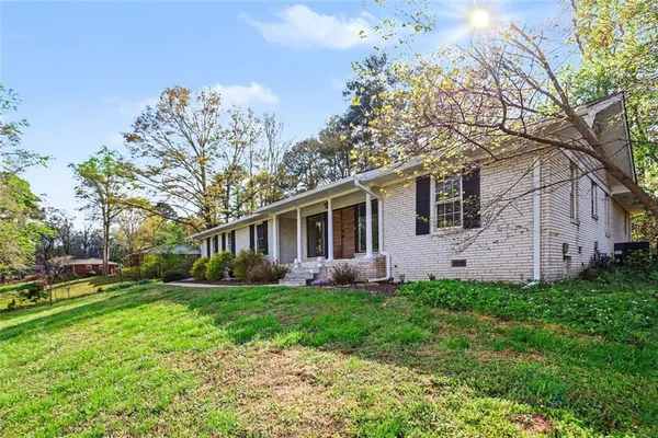 a front view of house with yard and green space