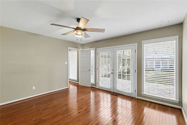 wooden floor in an empty room with a window
