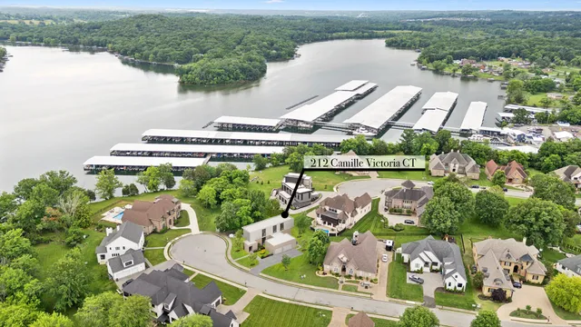 an aerial view of a house with outdoor space and a lake view