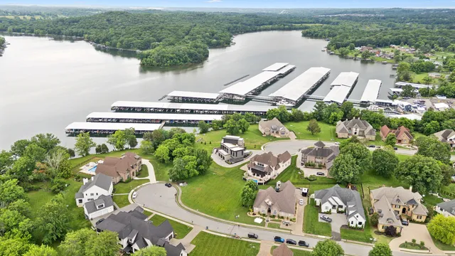 an aerial view of a house with outdoor space and a lake view