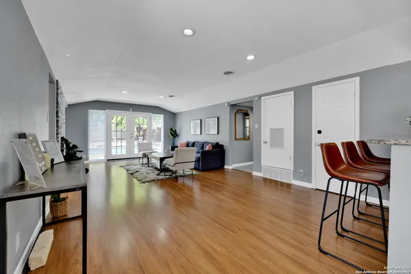 a living room with furniture a dining table and a potted plant