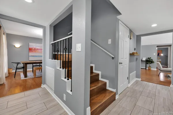 a bedroom with a bed and a wooden floor