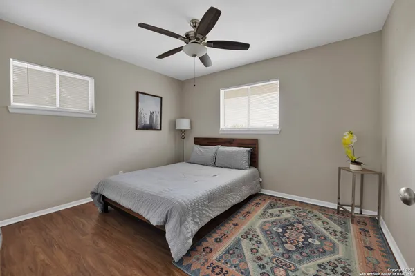 a bedroom with a bed and painting on the wall
