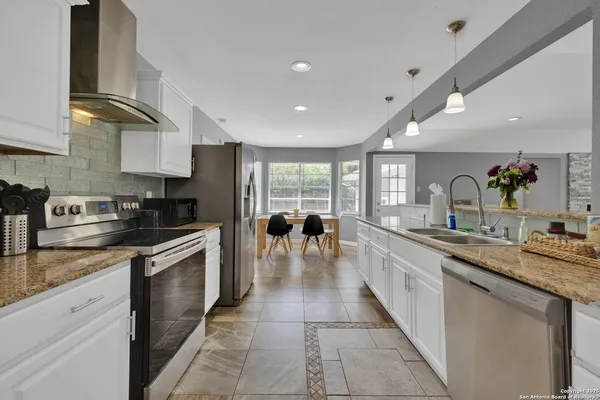 a kitchen with a stove and a refrigerator