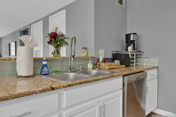 a kitchen with counter top space cabinets and appliances