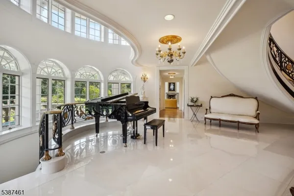 a view of a dining room with furniture and chandelier
