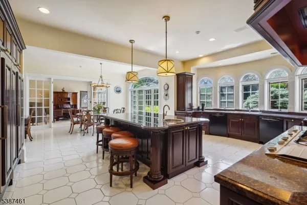 a living room with a black white checkered floor with a gaming machine and dining chair