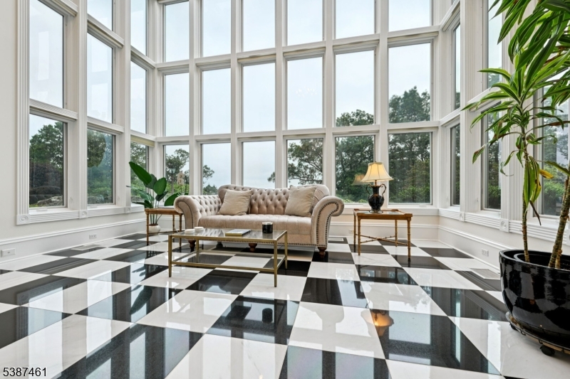 50 Laura Drive Cedar Grove, NJ 07009 - Photo 22 of 50 a living room with a black white checkered floor with a coffee table and chairs