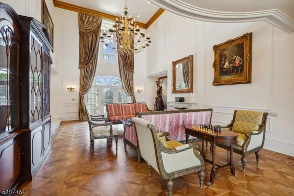 a view of a dining room with furniture a chandelier and wooden floor