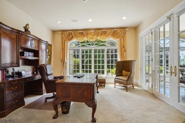a spacious bathroom with a granite countertop tub a sink and a large mirror