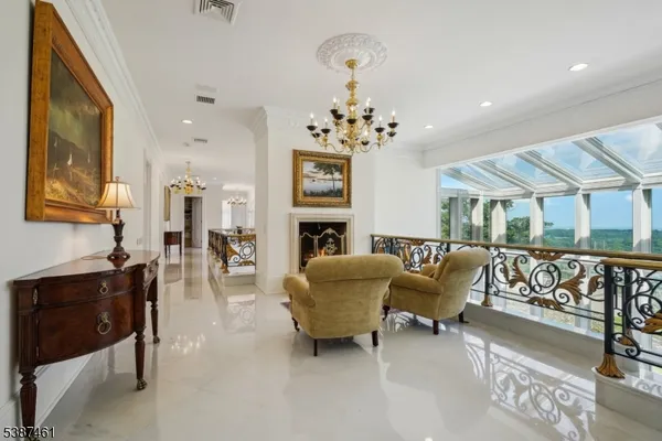 a spacious bedroom with a bed and a chandelier