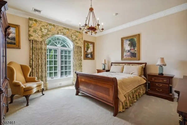 a spacious bedroom with a bed and wooden floor