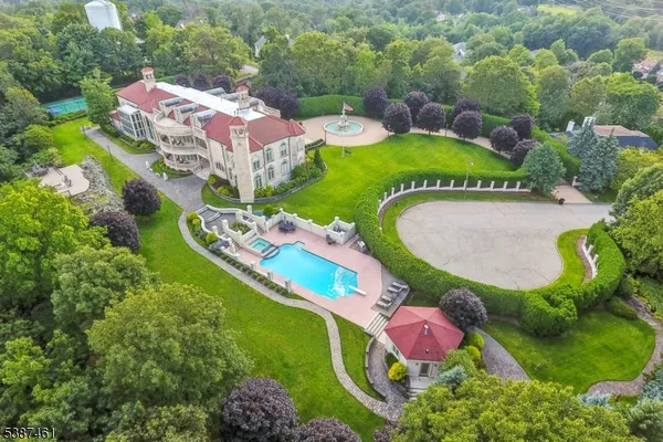 an aerial view of a house with outdoor space pool patio and lake view