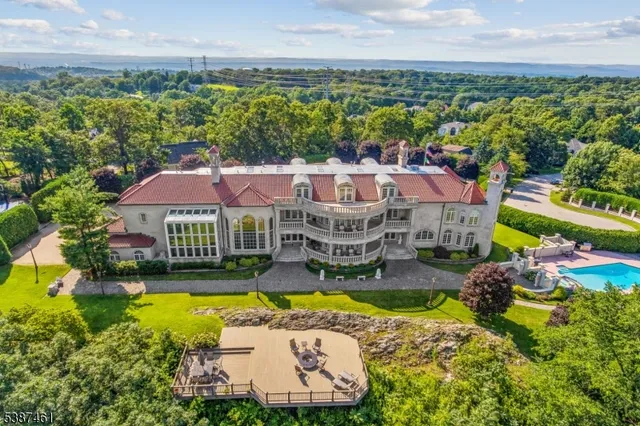 an aerial view of residential houses with swimming pool and outdoor space