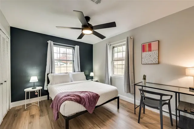 a bedroom with a large bed and a window