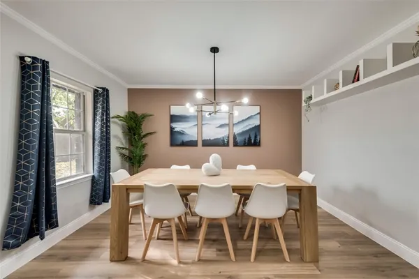a view of a dining room with furniture window and wooden floor