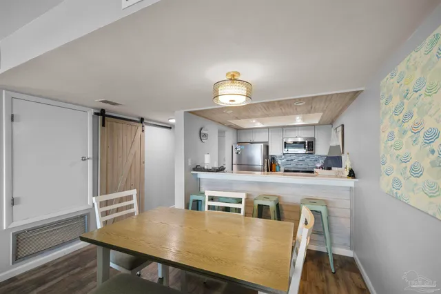 a view of a dining room with furniture wooden floor and a chandelier