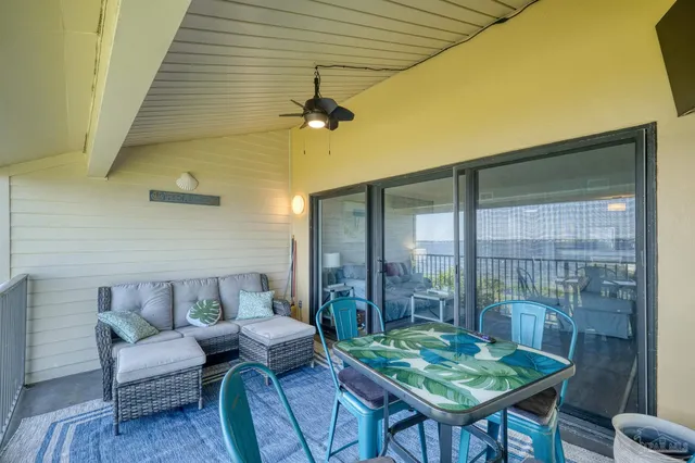 a balcony with furniture and a table