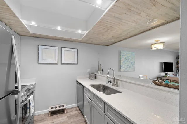 a kitchen that has a sink and a stove in it