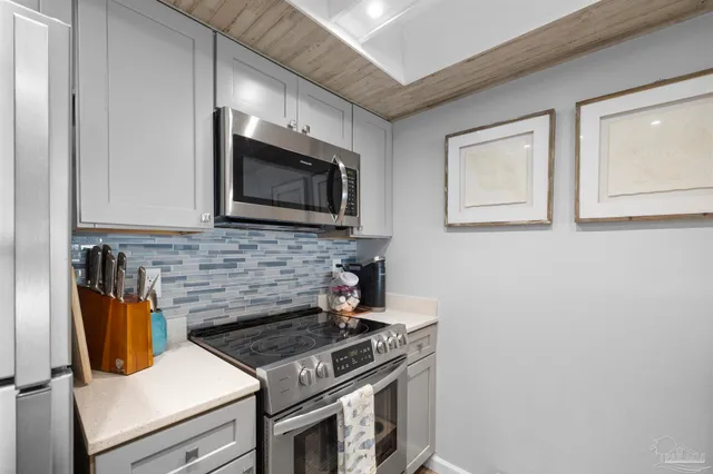 a kitchen with a stove and a microwave