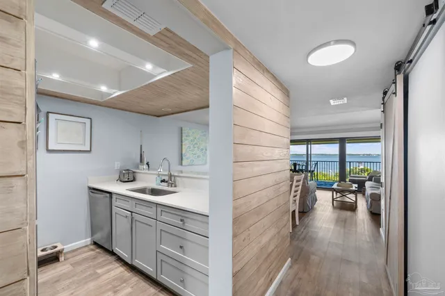 a kitchen with granite countertop cabinets and refrigerator