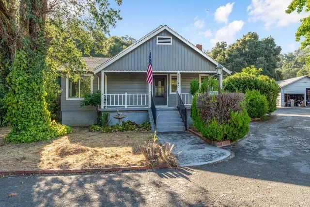 a view of a house with a yard and plants