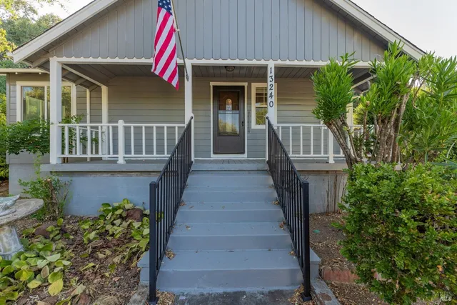 a view of a pathway of a house with wooden fence