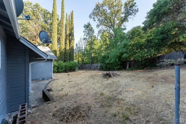 a backyard of a house with table and chairs