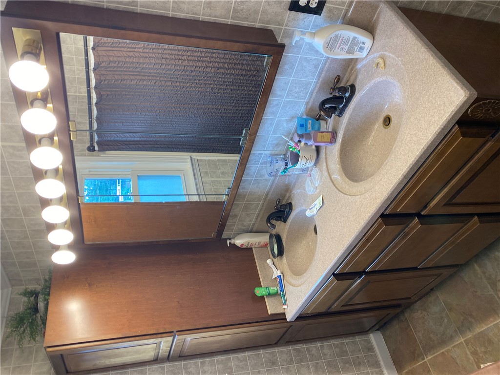 3 Heyward Avenue Honea Path, SC 29654 - Photo 14 of 35 This bathroom features a double vanity and ample storage space beneath.