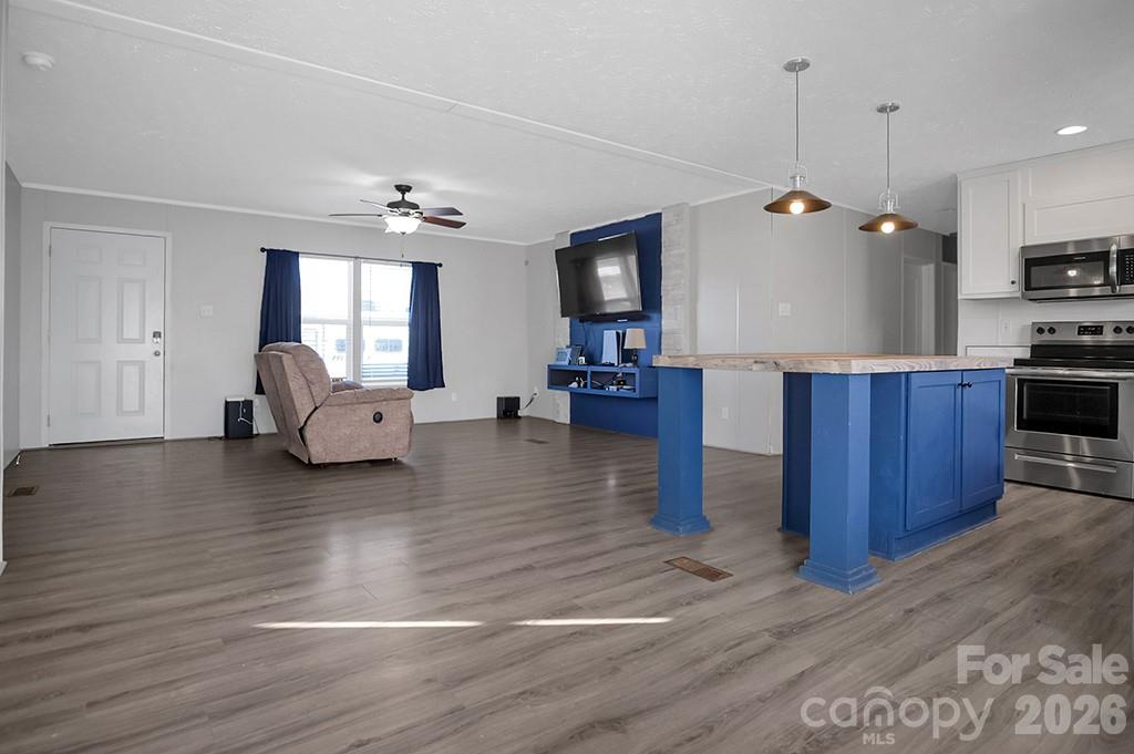 101 Park Lane Grover, NC 28073 - Photo 7 of 28 a living room with couches and kitchen view with wooden floor