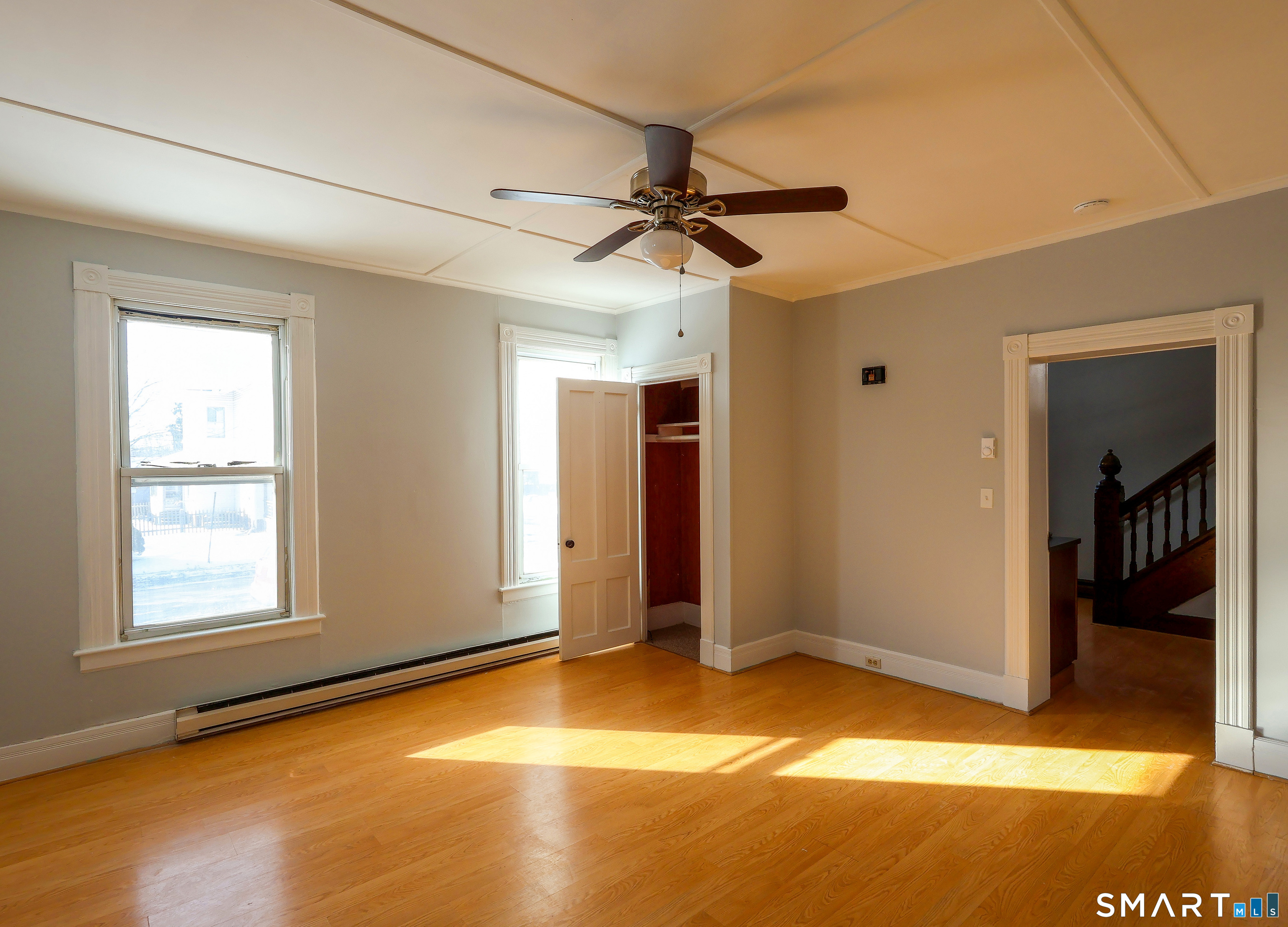 24 Fairview Street, Unit A Portland, CT 06480 - Photo 9 of 17 Bright, spacious living room with ceiling fan and coat closet