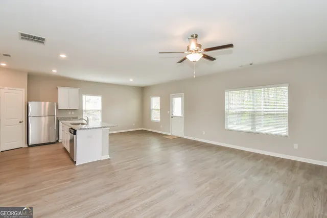 a view of a kitchen with a sink and a window