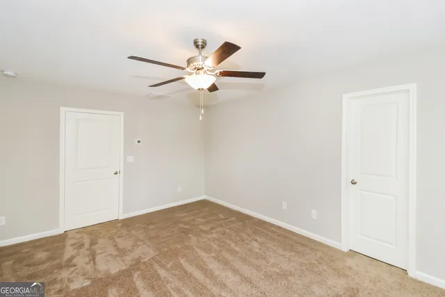 a view of a big room with carpet