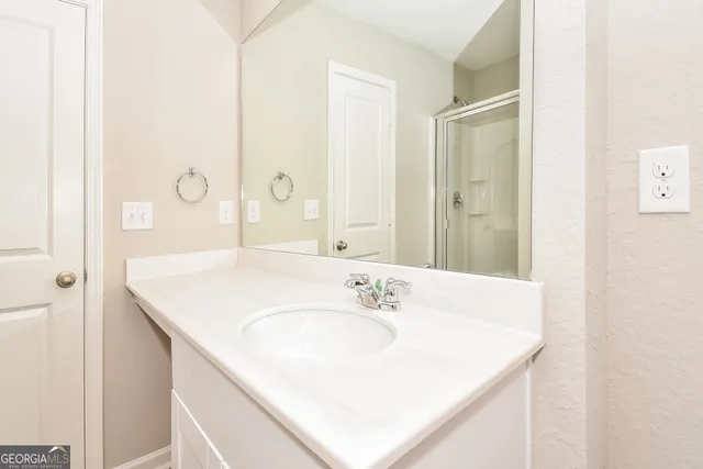 a bathroom with a sink vanity and a mirror
