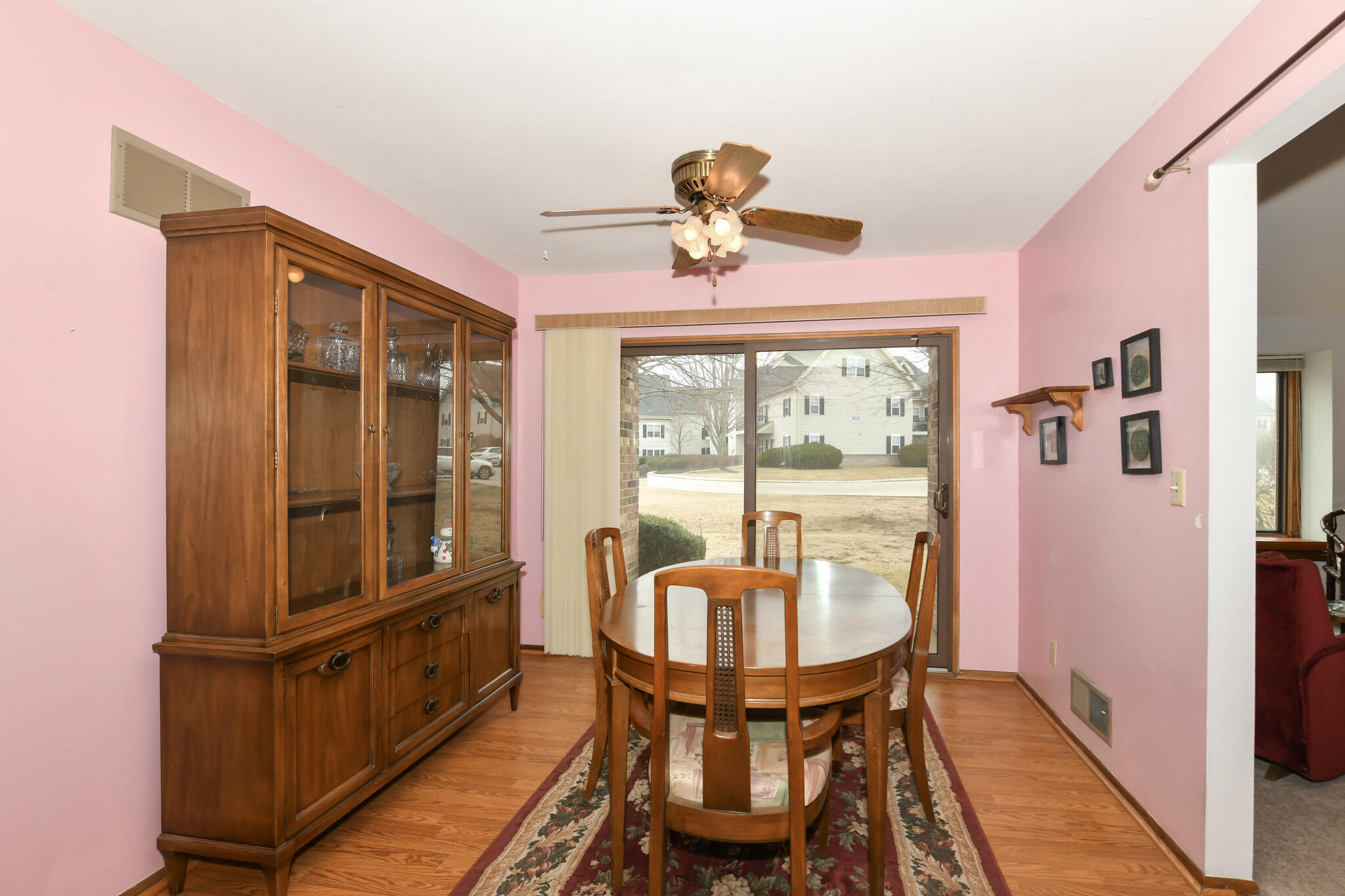 9632 West Bradley Road Milwaukee, WI 53224 - Photo 7 of 25 Sliding doors to patio, wood floors and ceiling fan.