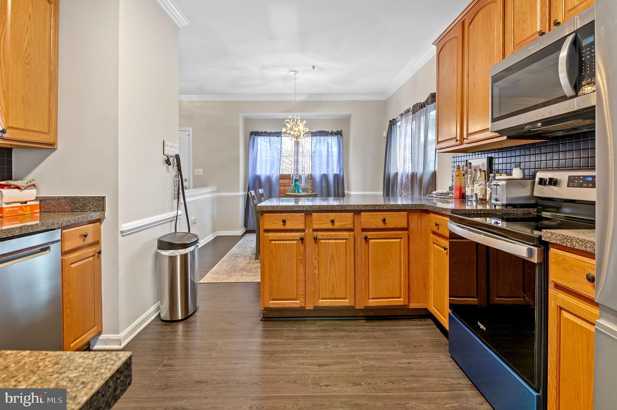 15511 Wylie Road Brandywine, MD 20613 - Photo 11 of 32 a kitchen with stainless steel appliances granite countertop a stove and a sink